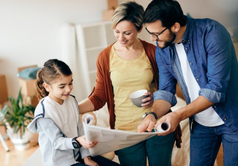 Happy family going through housing plans while moving into a new home